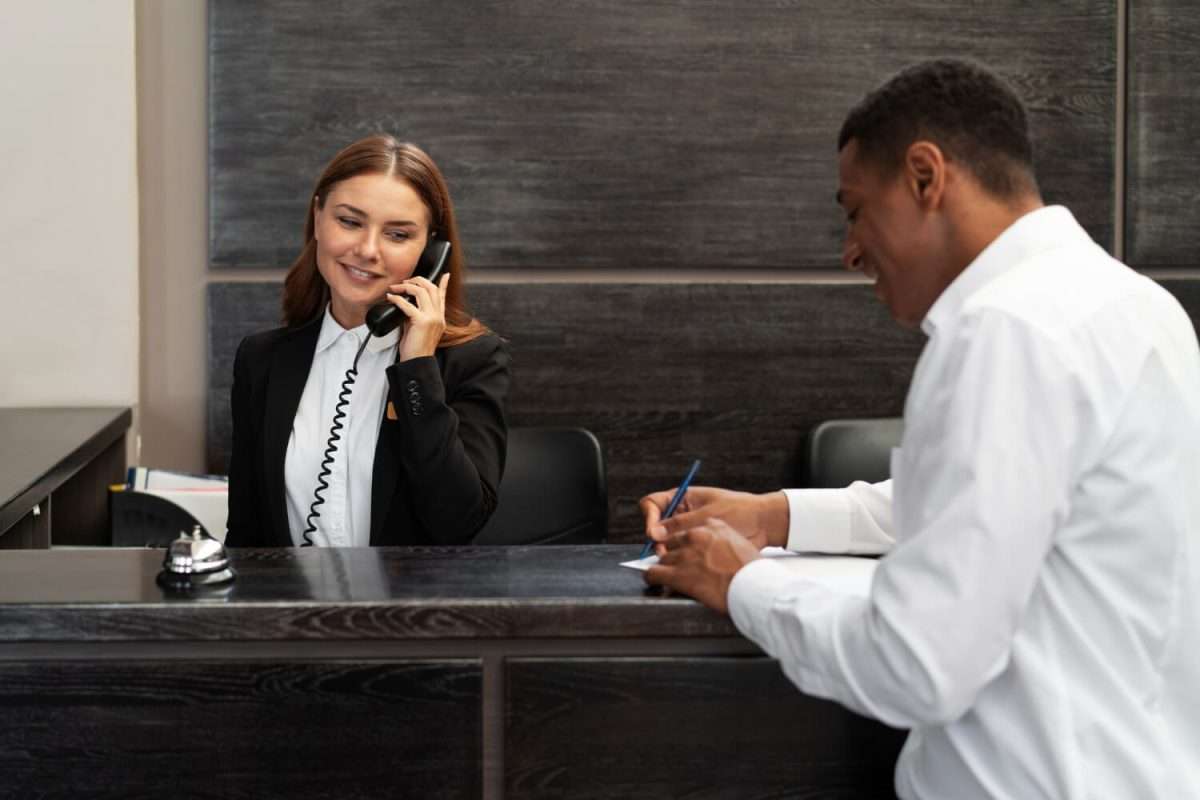 how to improve guest experience in hotel 1 - receptionist elegant suit during work hours with customer how to improve guest experience in hotel 1